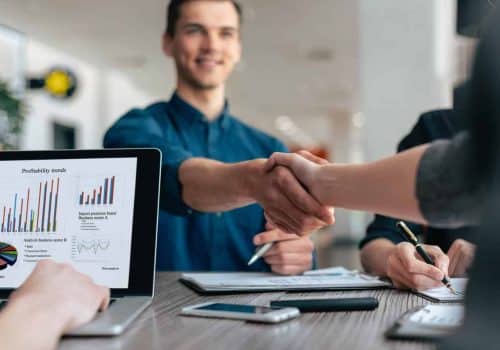 close-up-young-people-greeting-each-other-work-table-scaled.jpg